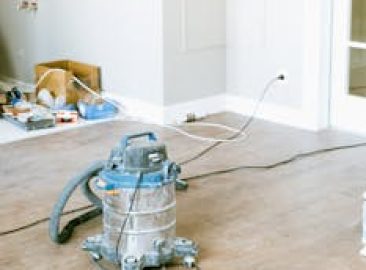 Vacuum and tools in a room undergoing renovation, showcasing home improvement.