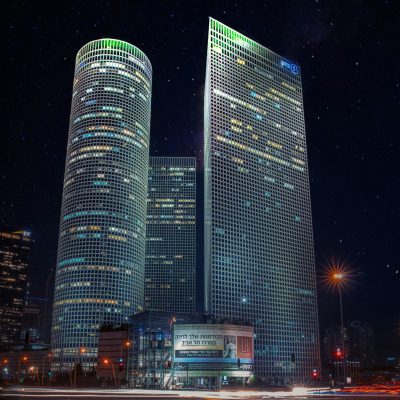 Stunning nighttime view of iconic skyscrapers in Tel Aviv under starry sky.